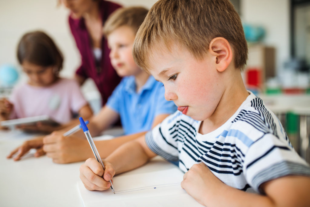 Students writing in the classroom