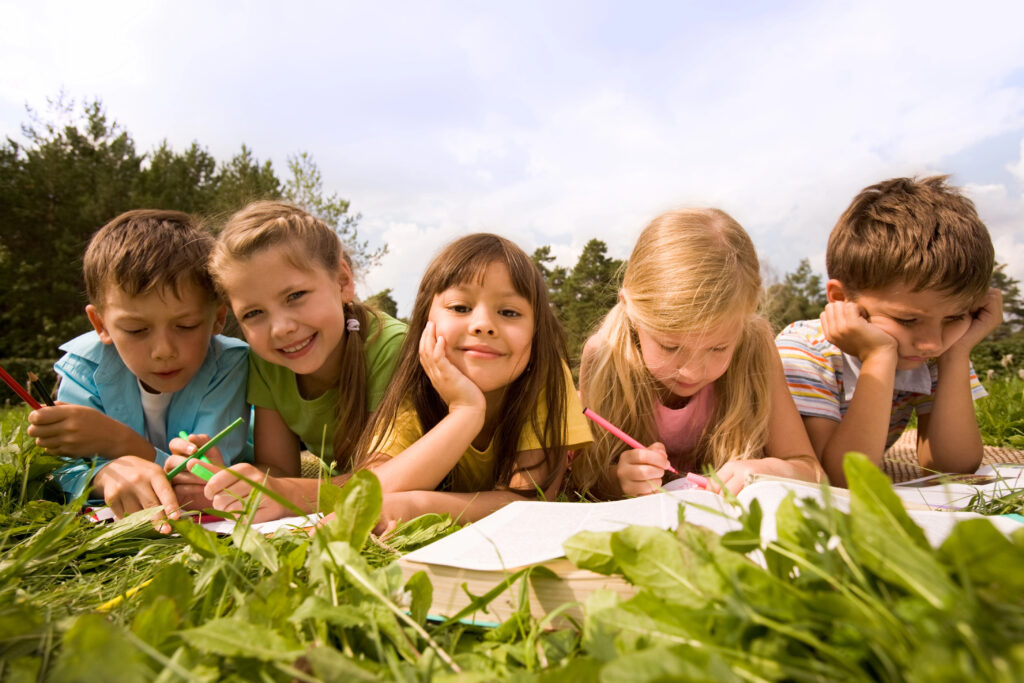 kids writing outside for summer school or occupational therapy handwriting activities